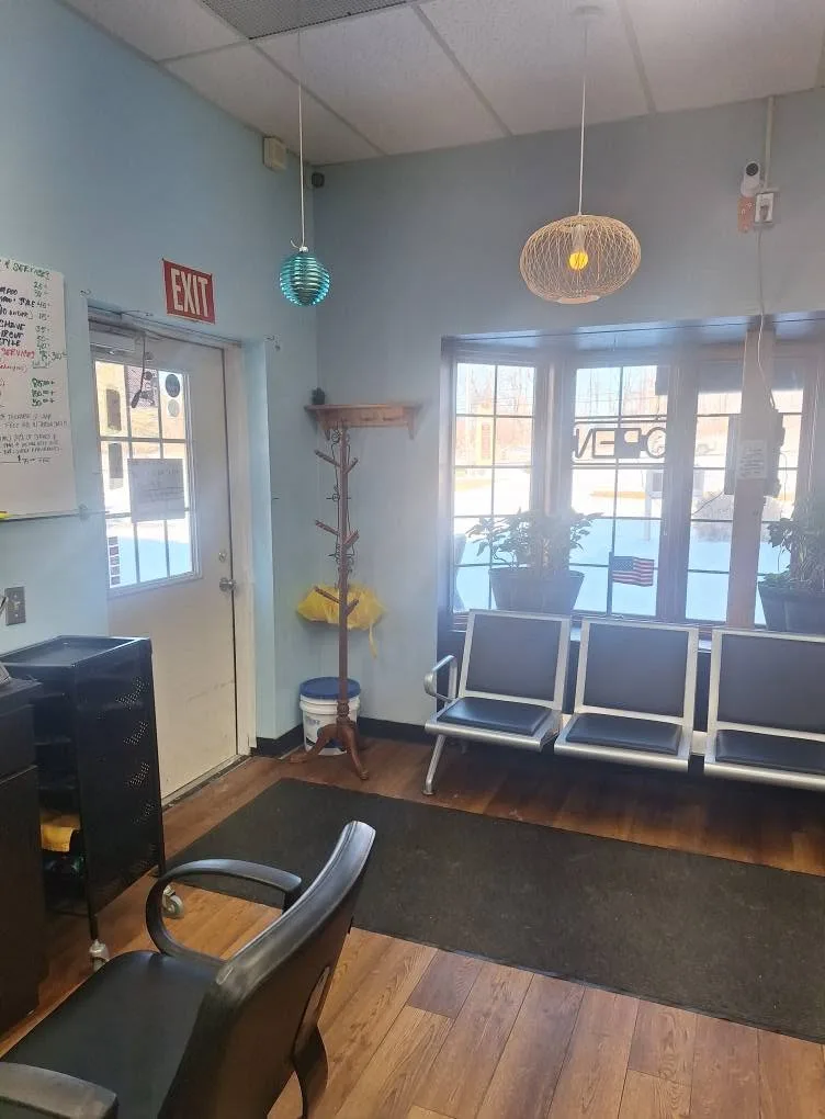 The waiting area: a row of chairs under the front bay window, beside the door